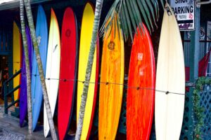 Vibrant surfboards on display at a surf shop in Haleiwa, Hawaii, showcasing tropical colors.